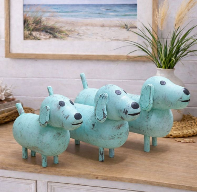 a set of 3 turquoise dog ornaments, wooden and hand painted with a chalky white paint
