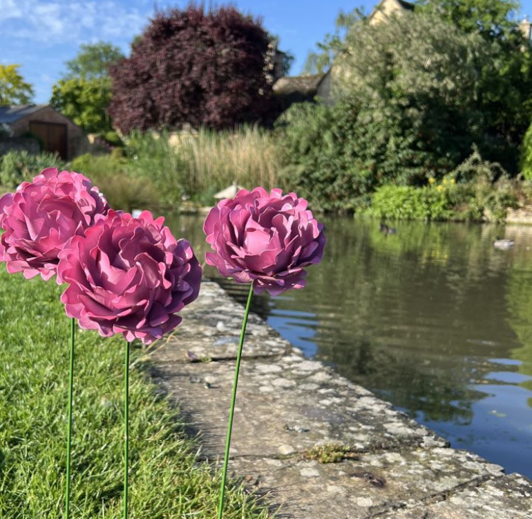 Image of a handcrafted metal red gerbera flower and stem