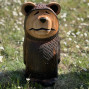 a hand carved outdoor wooden bear sculpture, smiling happy bear