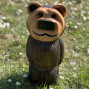 a hand carved outdoor wooden bear sculpture, smiling happy bear