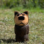 a hand carved outdoor wooden bear sculpture, tired squinty eyes