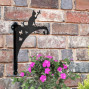 A silhouette of a black metal wall cat bracket for hanging baskets
