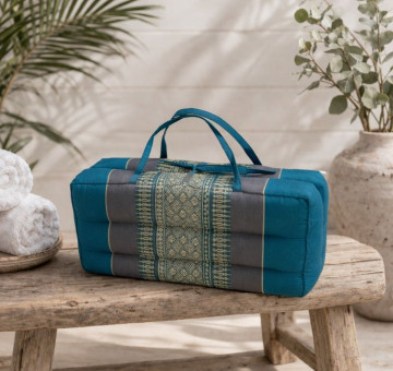 kapok filled handmade cushion shaped to give neck support, then foldable and able to tie up with carrying handles