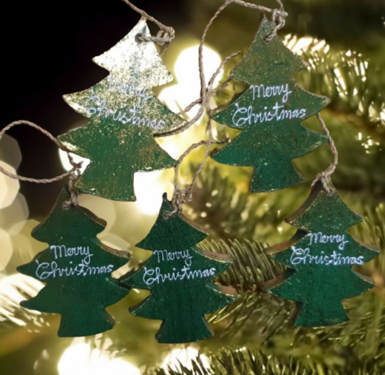 handmade and hand painted 5 green wooded christmas trees hanging on a garland string for seasonal decor
