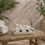 a white stone effect buddha on garden with incense sticks and candle