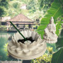 a white stone effect buddha on garden with incense sticks