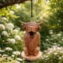 a hand carved bird nesting box in the shape of a highland cow with waves of fur