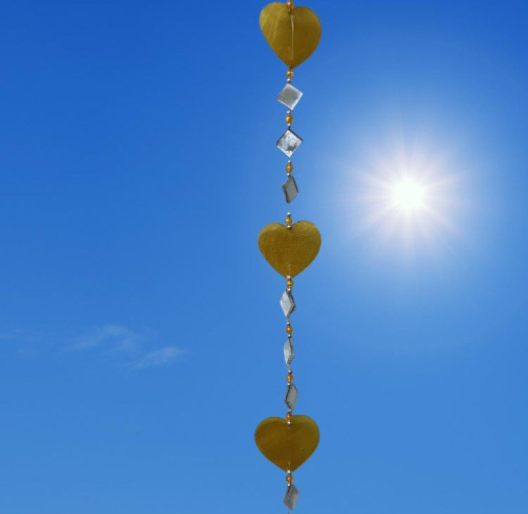 a hanging suncatcher made from mirrors and cut out shells