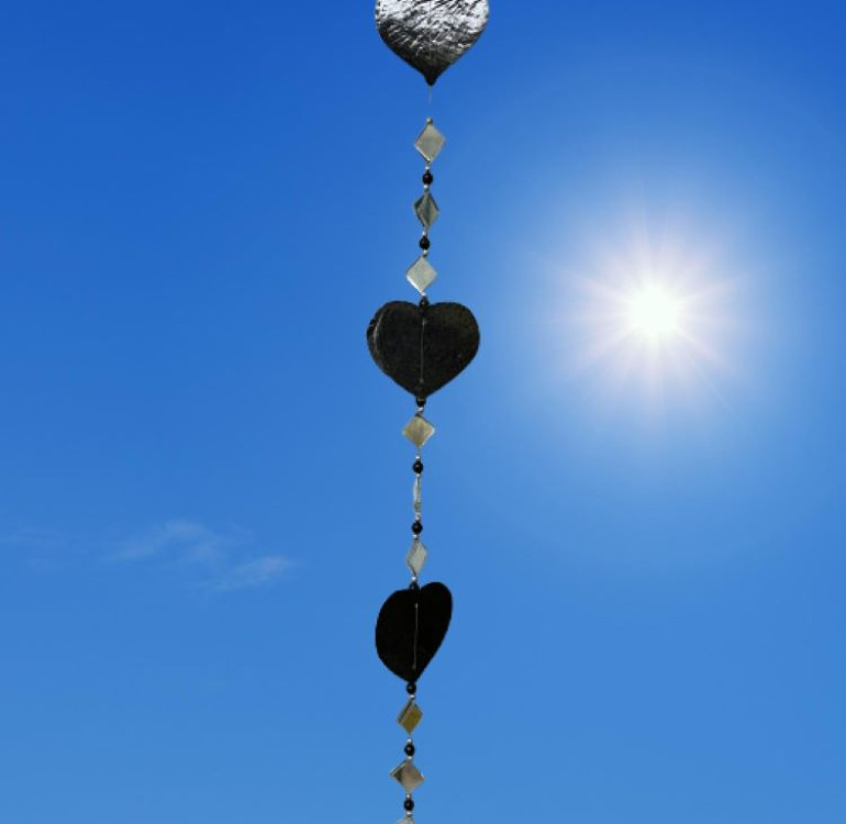 a hanging suncatcher made from mirrors and cut out shells