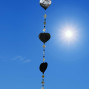 a hanging suncatcher made from mirrors and cut out shells