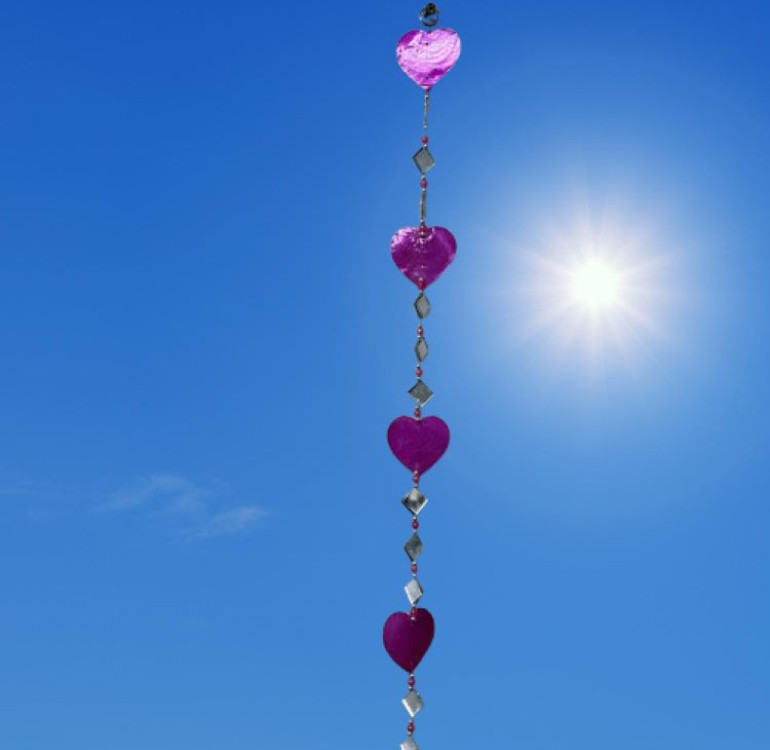 a hanging suncatcher made from mirrors and cut out shells