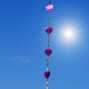 a hanging suncatcher made from mirrors and cut out shells