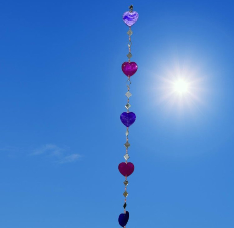 a hanging suncatcher made from mirrors and cut out shells