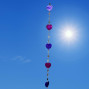 a hanging suncatcher made from mirrors and cut out shells