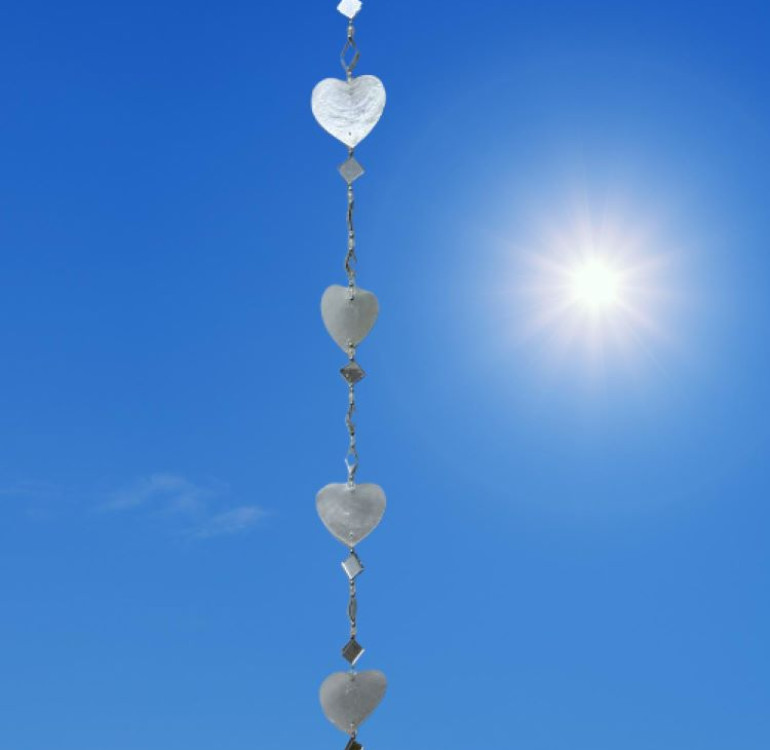 a hanging suncatcher made from mirrors and cut out shells