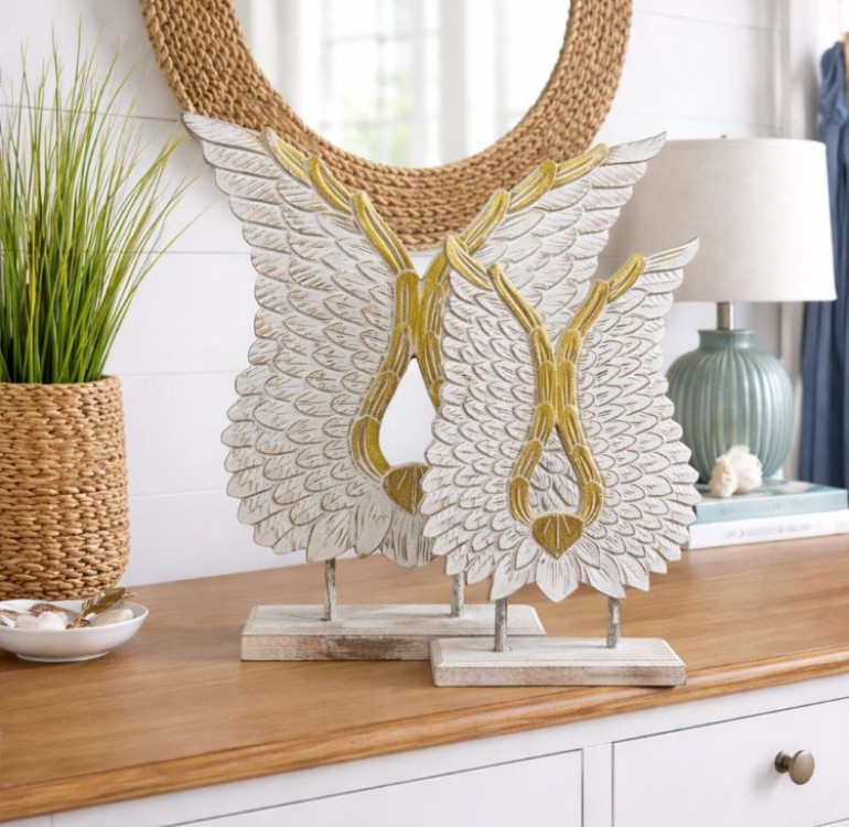 carved wooden angel wings on plinth