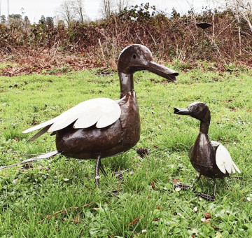 a family of handcrafted metal coloured outdoor ducks for the garden