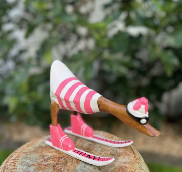 handmade bamboo skiing duck in a pink and white striped outfit with hat, goggles and skis