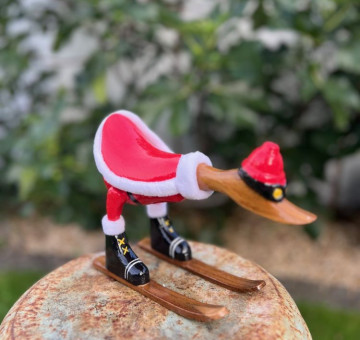 Handmade Skiing Bamboo Duck – Blue hat and boots Hit the slopes in style — or at least your shelf! Or perfect for a Waterskier friend. This charming handcrafted and hand-painted novelty duck is ready for winter fun, complete with goggles, skis, and a hat. Lovingly carved from sustainable bamboo and hand-finished by skilled artisans, each duck has its own personality and playful charm. Whether you're a winter sports fan, watersports or just love unique décor, this duck is sure to bring a smile. Handmade from natural bamboo Hand-painted with goggles & hat Freestanding with attached skis A perfect gift or quirky decoration Each piece is one of a kind Bring a bit of alpine joy into your home — no snow required! Handmade in Indonesia from Bamboo. The Duck is approximately 24cm in length, differs due to head position. Each duck is handcarved and hand painted so may differ slightly from image shown.