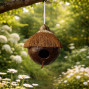 a handmade coconut nesting box with entrance hole and perch