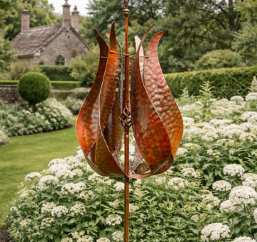 The Painswick Metal Garden Wind Spinner on a stake